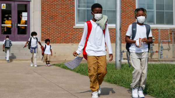 Jerrell Brown (left), 9, walks with Jayce Williams,