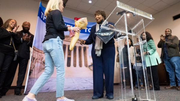 Judge Nancy Kennedy hands a dozen roses to U.S. Rep. Eddie Bernice Johnson