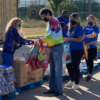 Mavs Care Volunteers Stuffing Food Bags