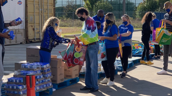 Mavs Care Volunteers Stuffing Food Bags