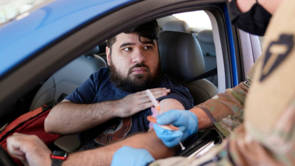 Sitting in his car, social worker Jonathan De La Rosa