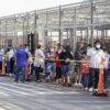 People wait in line at a COVID-19 vaccination