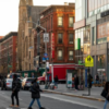 Pedestrians cross 125th Street in Harlem