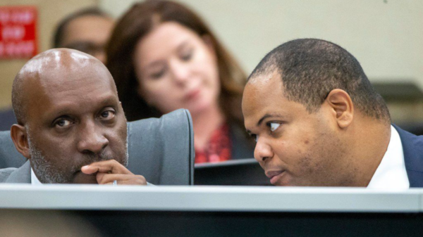 Dallas City Manager T.C. Broadnax, left, listens to Mayor Eric Johnson