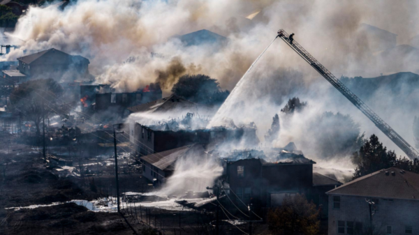 Fire fighters battle a grass fire