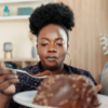 Overweight African American Woman Eating Junk Food