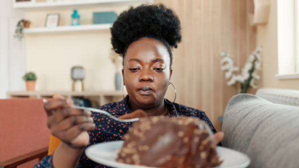 Overweight African American Woman Eating Junk Food