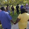 Residents pray near the store