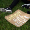 A demonstrator lays a sign on the ground