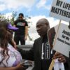 Attorney Benjamin Crump, right, talks with Chelsie Rubin