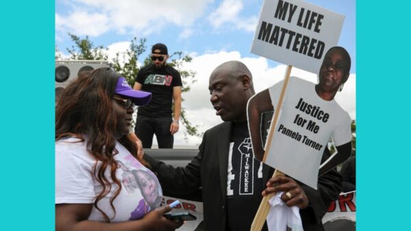 Attorney Benjamin Crump, right, talks with Chelsie Rubin