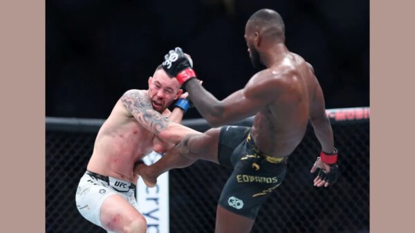 (R-L) Leon Edwards of Great Britain kicks Colby Covington