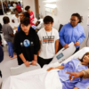 Students surround one of the several mannequins for health