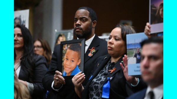 Family members hold up photos