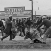 An Alabama state trooper swings a club