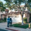 Couple in front of house