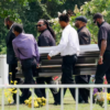 Pallbearers carry