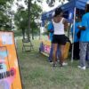 People gather around a registration tent