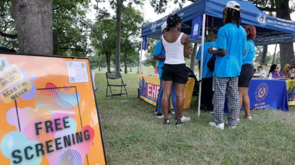 People gather around a registration tent